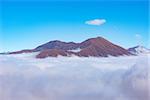 Mountain top above the clouds at autumn evening time. Caucasus. Russia.