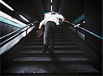 Delayed businessman with bag runs on the stairs
