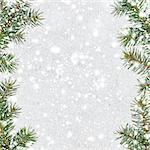 christmas card or new year background made of glittering snowflakes with fir-tree branches