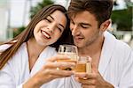 Young couple  in a luxury hotel tasting a glass of white wine