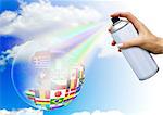 Hand with aerosol spray paints ball in the colors of national flags on sky background. The concept of world community