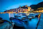 View of blue sea and boats surrounding the colorful village at dusk, Portovenere, UNESCO World Heritage Site, La Spezia Province, Liguria, Italy, Europe