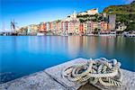 View from the pier of blue sea which frames the typical colored houses of Portovenere, UNESCO World Heritage Site, La Spezia Province, Liguria, Italy, Europe