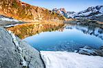 Snowy peaks reflected in Lake Zana at sunrise, Malenco Valley, Valtellina, Province of Sondrio, Lombardy, Italy, Europe