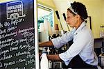 Woman standing in a mobile coffee shop.