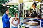 Man and woman standing at the counter of a mobile coffee shop.