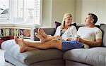 A couple, man and woman relaxing on the sofa.