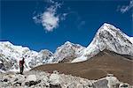 A trekker in the Everest region on the way up to Everest Base Camp, a view of Pumori in the distance, Khumbu Region, Himalayas, Nepal, Asia