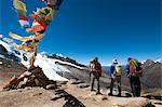 A windy prayer flag strewn cairn marks the top of the Kagmara La, the highest point in the Kagmara Valley at 5115m, Dolpa Region, Himalayas, Nepal, Asia