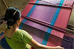 A woman weaves traditional clothes using a hand loom, Chittagong Hill Tracts, Bangladesh, Asia