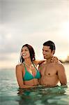 Smiling mid adult couple swimming at a tropical beach.