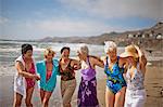 Happy mature friends enjoying a day at the beach.