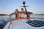 Mature couple travelling in motorboat, portrait