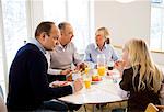 Family sitting around table eating breakfast