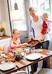 Mother and children having dinner