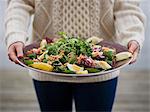 Woman with a plate of salad with crab, Sweden.