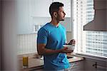 Man having breakfast in the kitchen at home