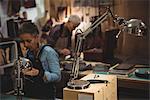 Attentive craftswoman working in workshop