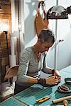 Attentive craftswoman working in workshop