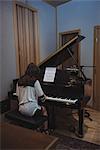 Woman playing a piano in music studio