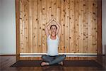 Woman performing yoga in fitness studio