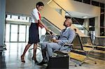 Businessman giving his passport to airline check-in waiting area at airport