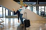 Happy couple embracing each other at the airport