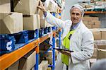 Portrait of technician maintaining records on digital tablet at meat factory