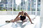 Ballerina doing stretching exercise in the ballet studio