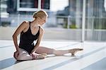 Ballerina performing a split in the ballet studio