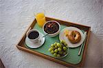 Close-up of breakfast tray on bed in bedroom at home