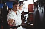 Karate player performing karate stance in fitness studio