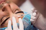 Man receiving botox injection on his forehead at clinic