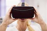 Female doctor wearing virtual reality headset in clinic