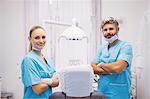 Portrait of dentist standing with arms crossed at dental clinic