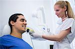 Dentist taking a male patients tooth x-ray in clinic