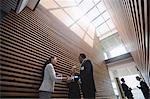 Businesspeople having tea and interacting during breaktime in office