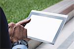 Close-up of a businessman using digital tablet outside office building