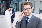 Confident businessman talking on mobile phone