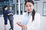 Portrait of a businesswoman using mobile phone in office