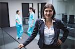 Portrait of smiling female doctor in hospital corridor