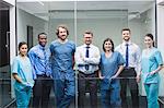 Portrait of smiling doctors standing together in corridor at hospital