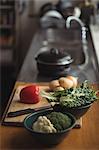 Potatoes, onion, lettuce with broccoli on cutting board in kitchen worktop