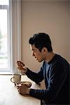 Man having a bowl of cereals at home