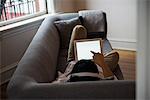 Man listening music on digital tablet at home