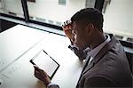 Businessman using digital tablet in office