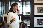 Businesswoman talking on mobile phone in office