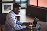 Businessman using laptop in office