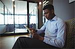 Portrait of businessman using digital tablet in office