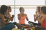 Women gesturing with fists in exercise class gym studio